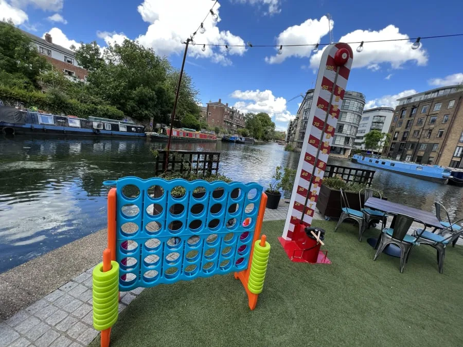 Red and white traditional high striker set up at an outdoor event